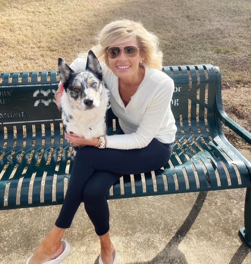Owner with her calm dog on a bench